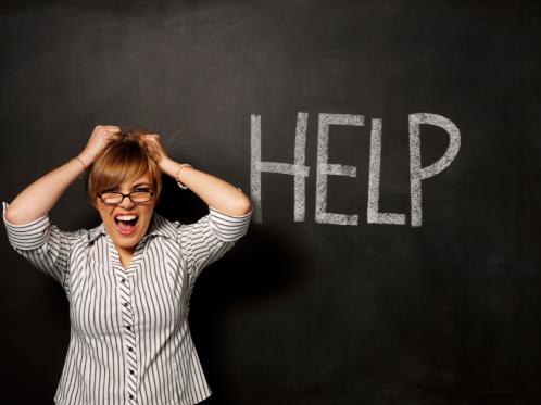 Mother pulling hair out in front of chalkboard that reads 