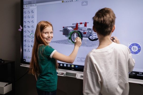 Students designing a robot on a magic whiteboard