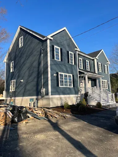 A large house with a lot of windows is being built.