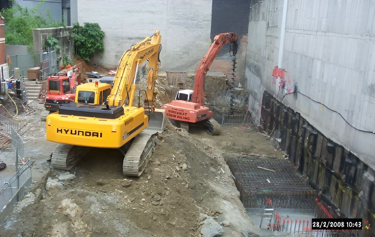 A Yellow Excavator is Working in a Construction Site — Q-Pile Foundations in Coolum Beach, QLD