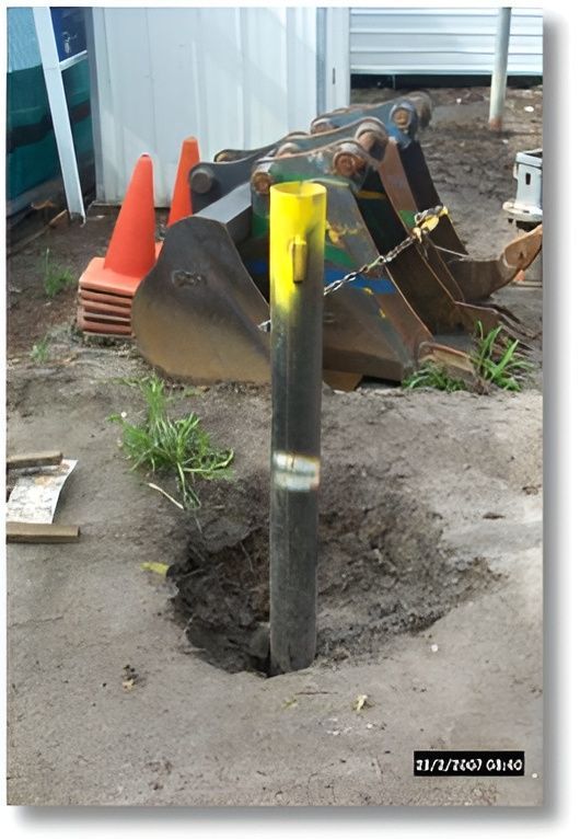 A Yellow and Black Pole is in the Dirt Next to a Pile of Orange Cones — Q-Pile Foundations in Coolum Beach, QLD