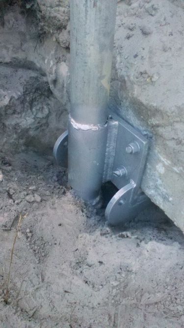 A Metal Pole is in the Dirt Next to a Rock — Q-Pile Foundations in Coolum Beach, QLD