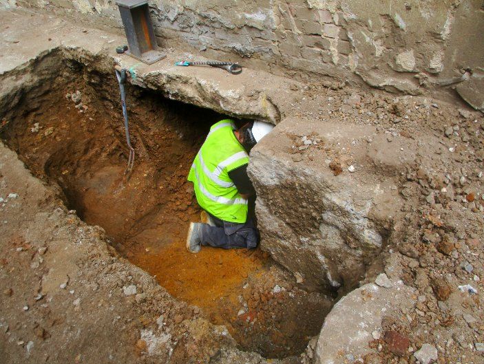 A Man in a Working Vest is Kneeling in a Hole in the Ground — Q-Pile Foundations in Nambour, QLD