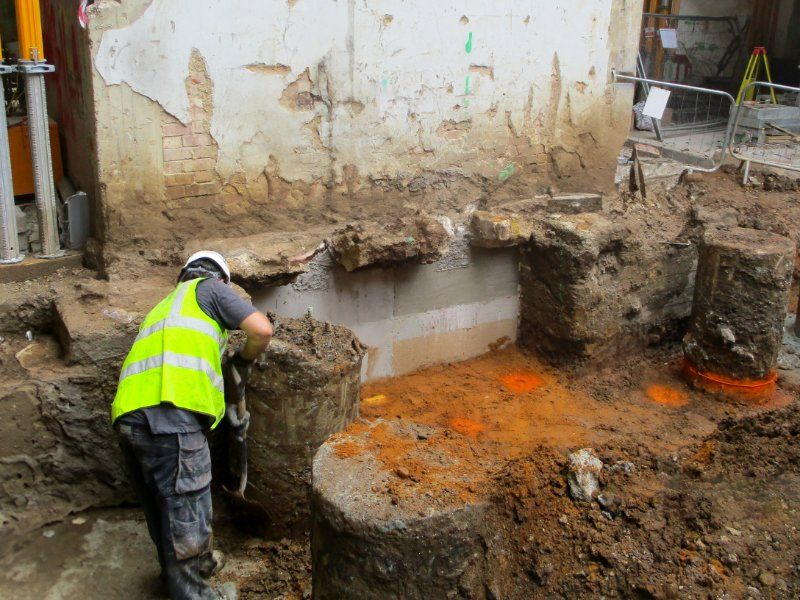 A Man in a Vest is Working on a Construction Site — Q-Pile Foundations in Maroochydore, QLD