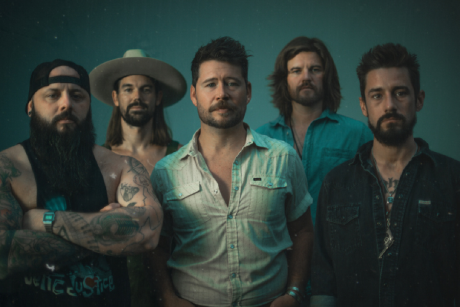 A group of men are posing for a picture together.