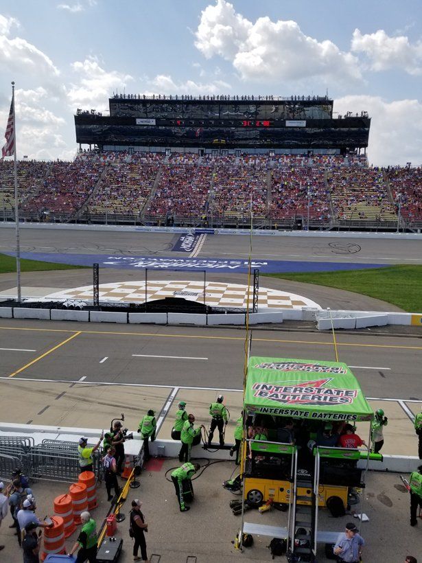 A race track with a large stadium in the background