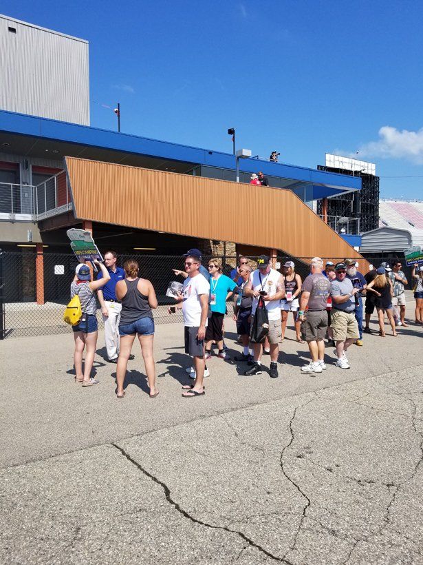 A group of people are standing in front of a building.