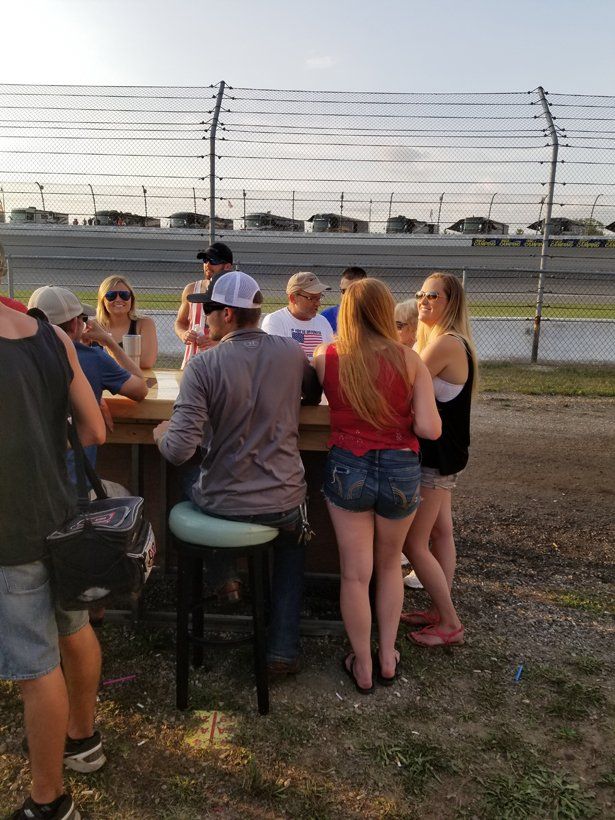 A group of people are sitting at a table outside.