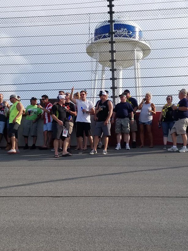 A group of people standing in front of a water tower