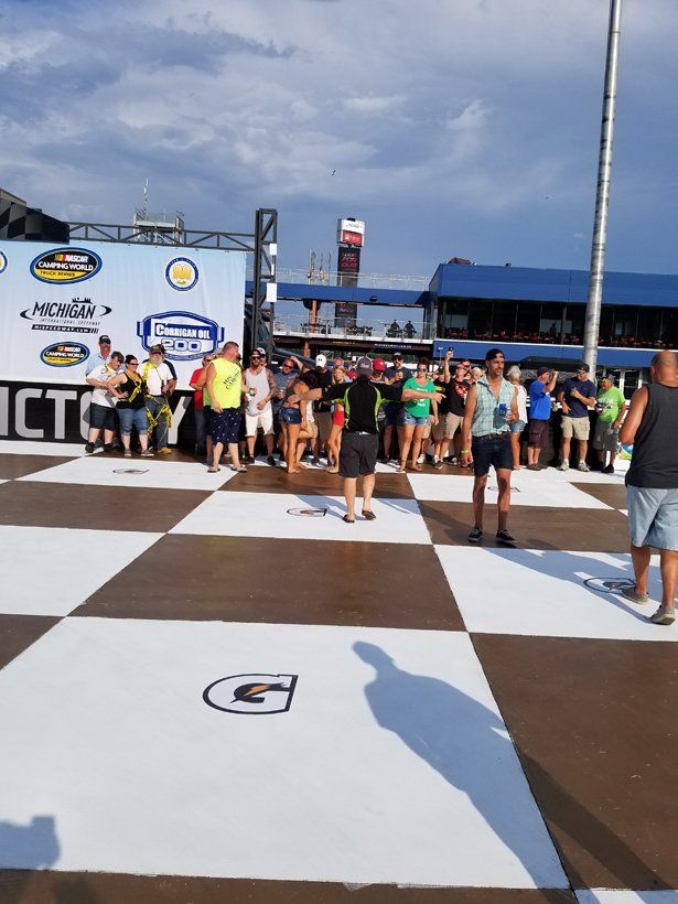A group of people are standing on a checkered floor.
