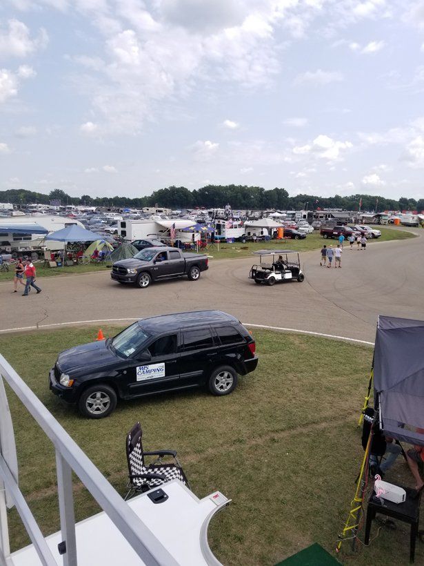 A black suv is parked in a grassy field.