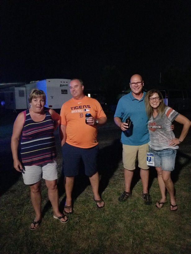 A group of people standing next to each other in a field at night.