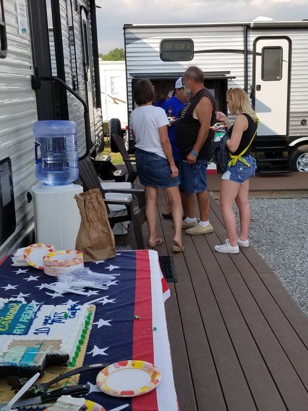A group of people are standing around a table with an american flag on it.