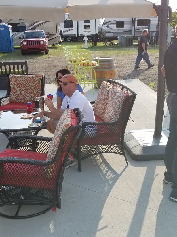 A group of people are sitting at a table under an umbrella