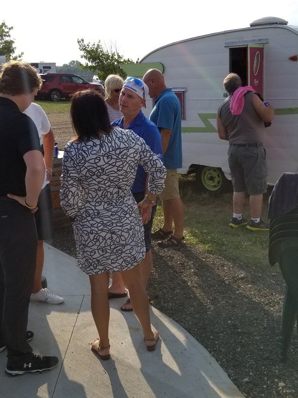 A group of people standing in front of a trailer
