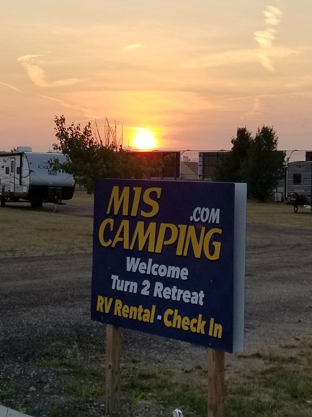 A sign that says mis camping welcome turn 2 retreat rv rental check in