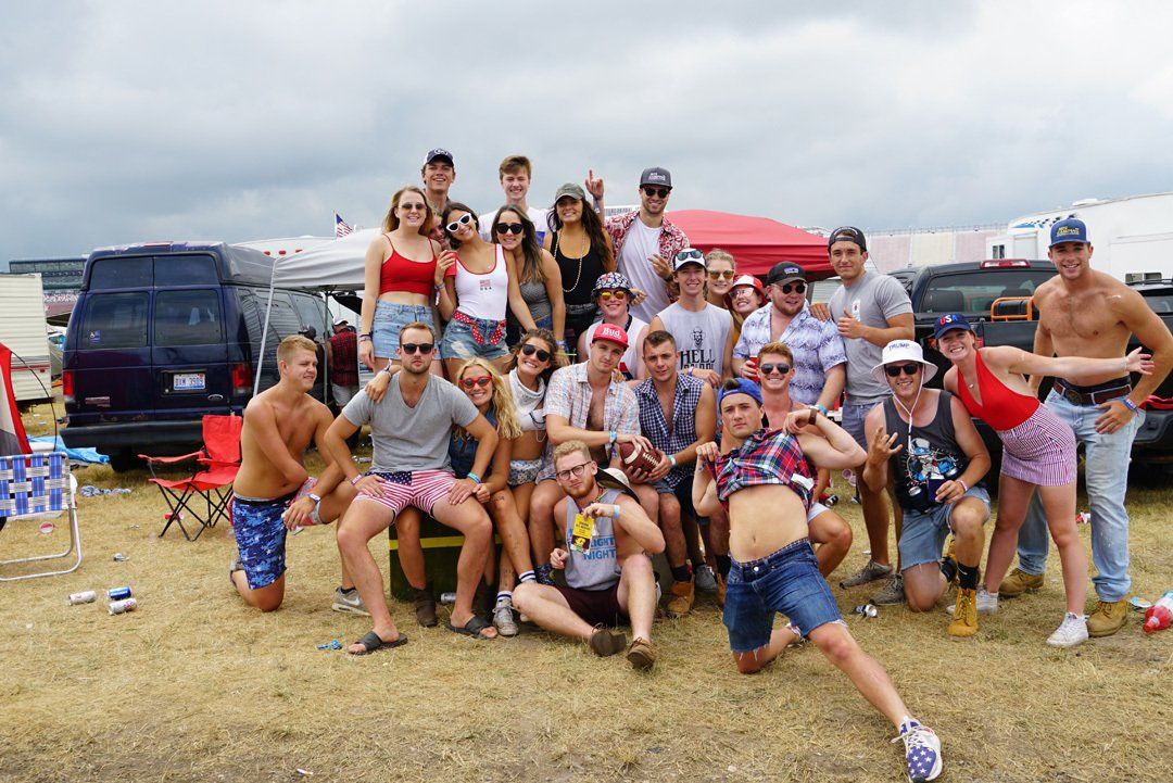 A group of people are posing for a picture in a field.
