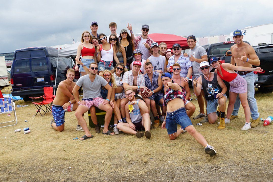 A group of people are posing for a picture in a field.