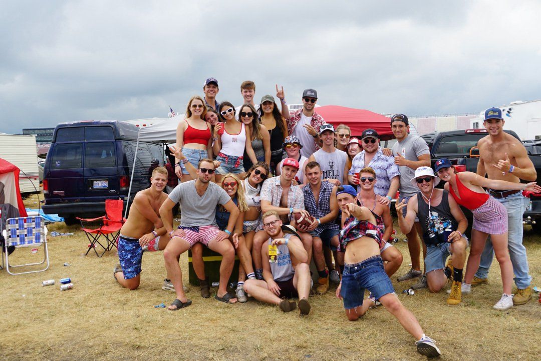 A group of people are posing for a picture in a field.