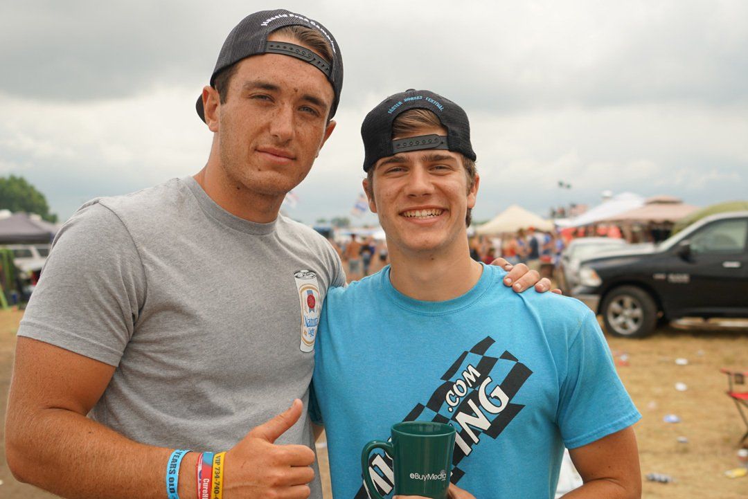 Two young men posing for a picture with one wearing a shirt that says racing. Alex Wilder and Alex Winnie