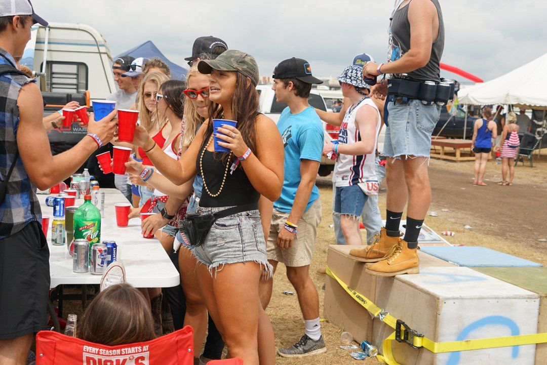 A group of people are standing around a table at a festival.