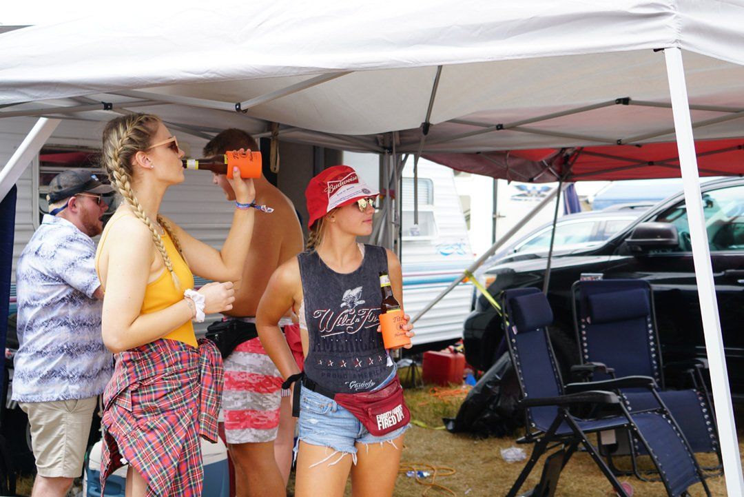 A group of people are standing under a tent.