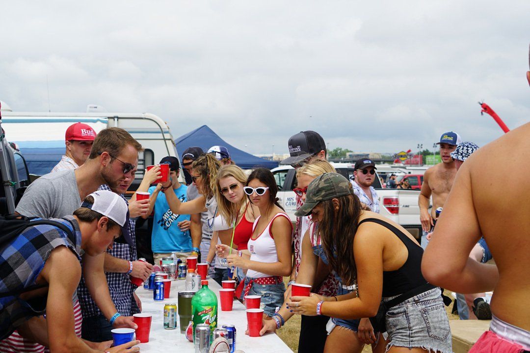 A group of people are gathered around a table with drinks.