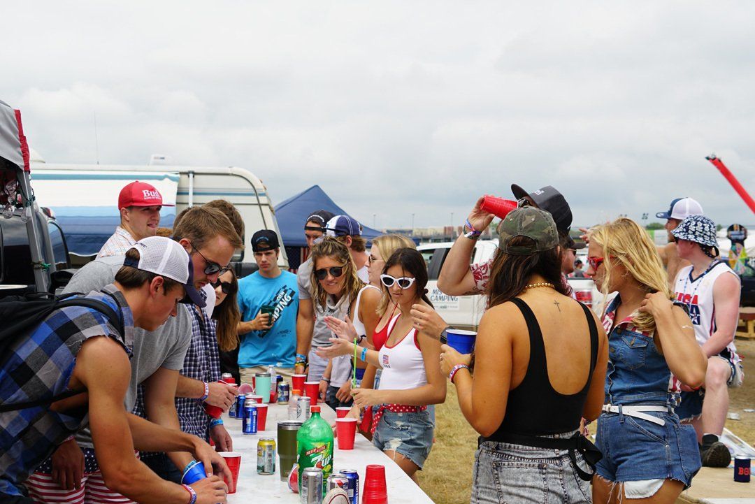A group of people are standing around a table at a party.