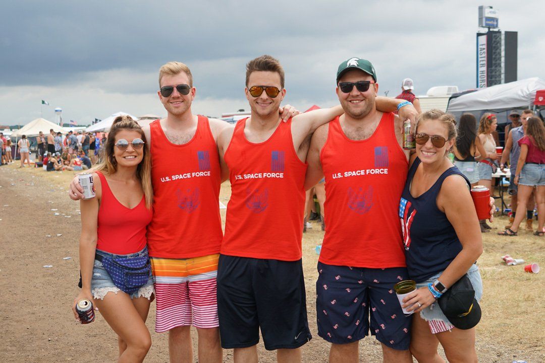 A group of people are posing for a picture in a field.