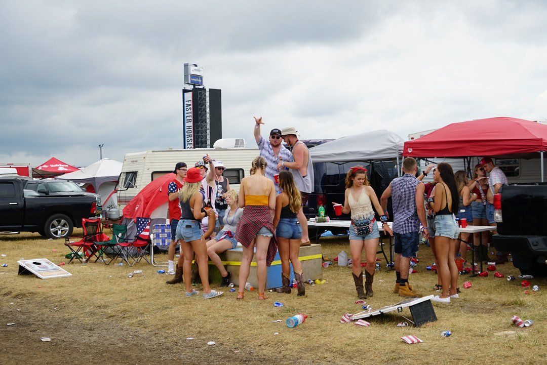 A group of people are standing in a field.