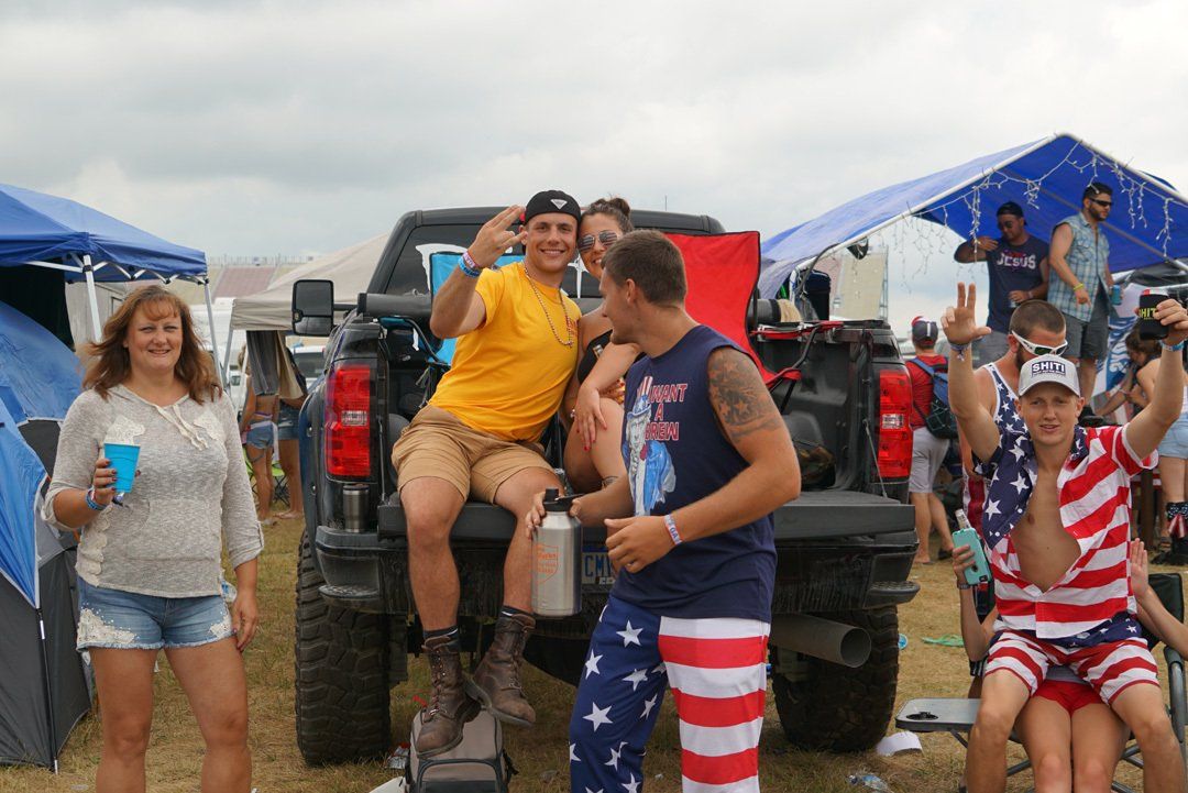 A group of people are standing around a truck.