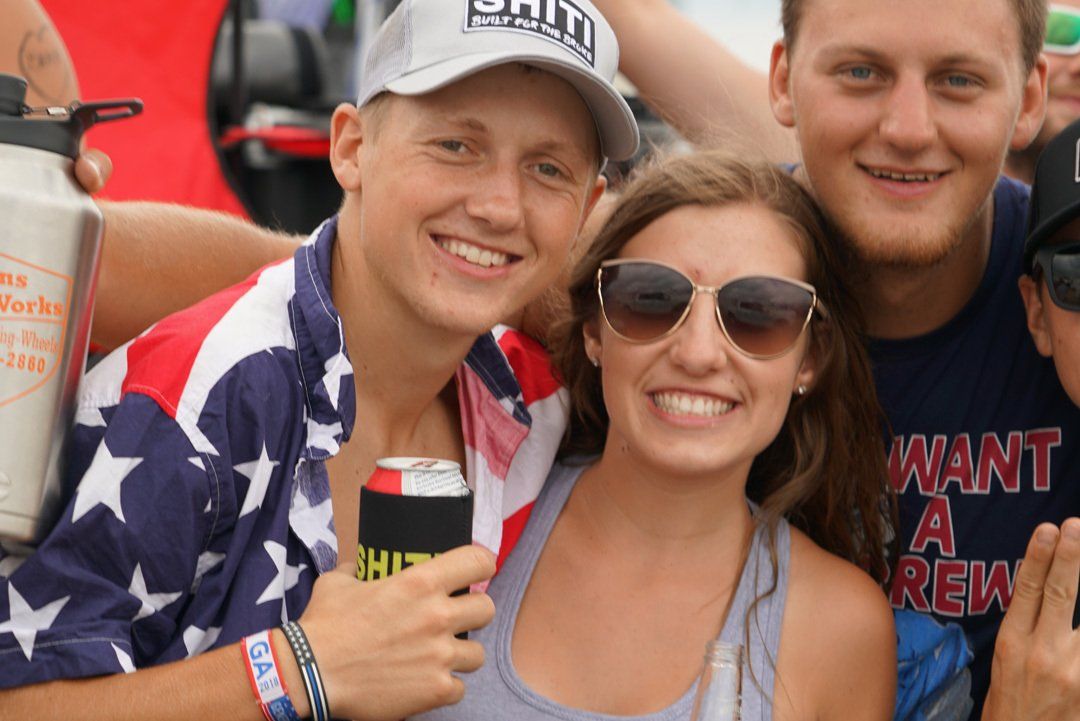 A group of people posing for a picture with one wearing a shirt that says want a new job
