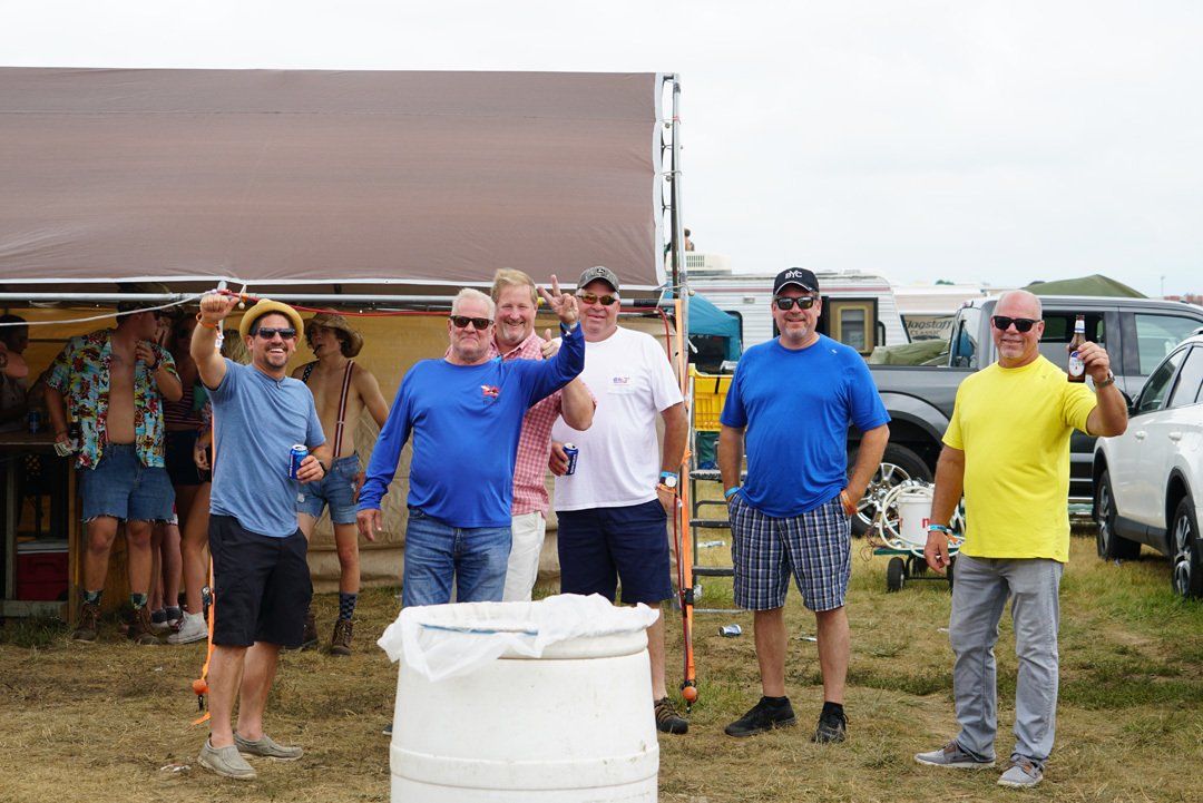 A group of men are standing next to each other in a field.