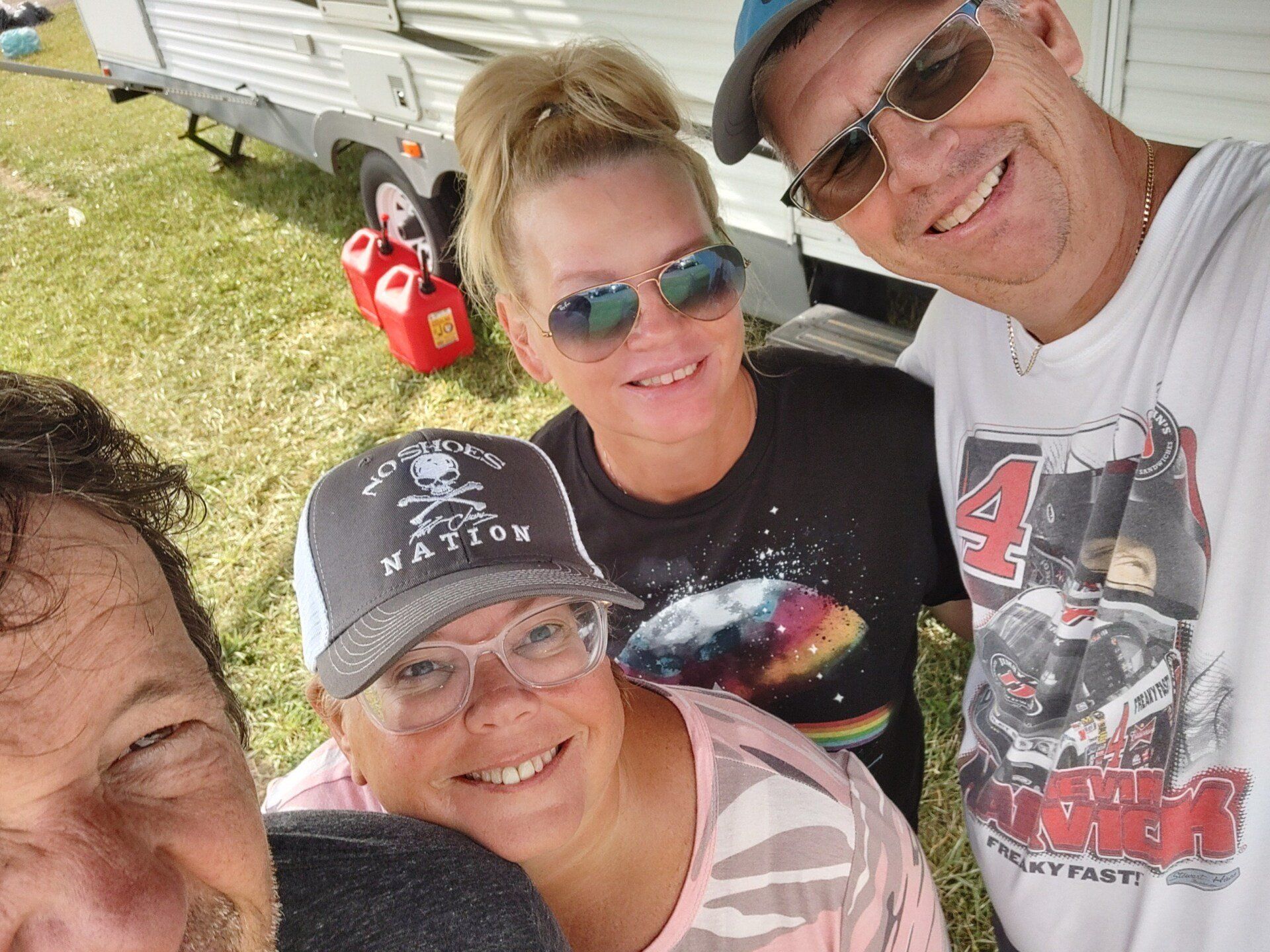 A group of people are posing for a picture and one of them is wearing a shirt with the number 4 on it