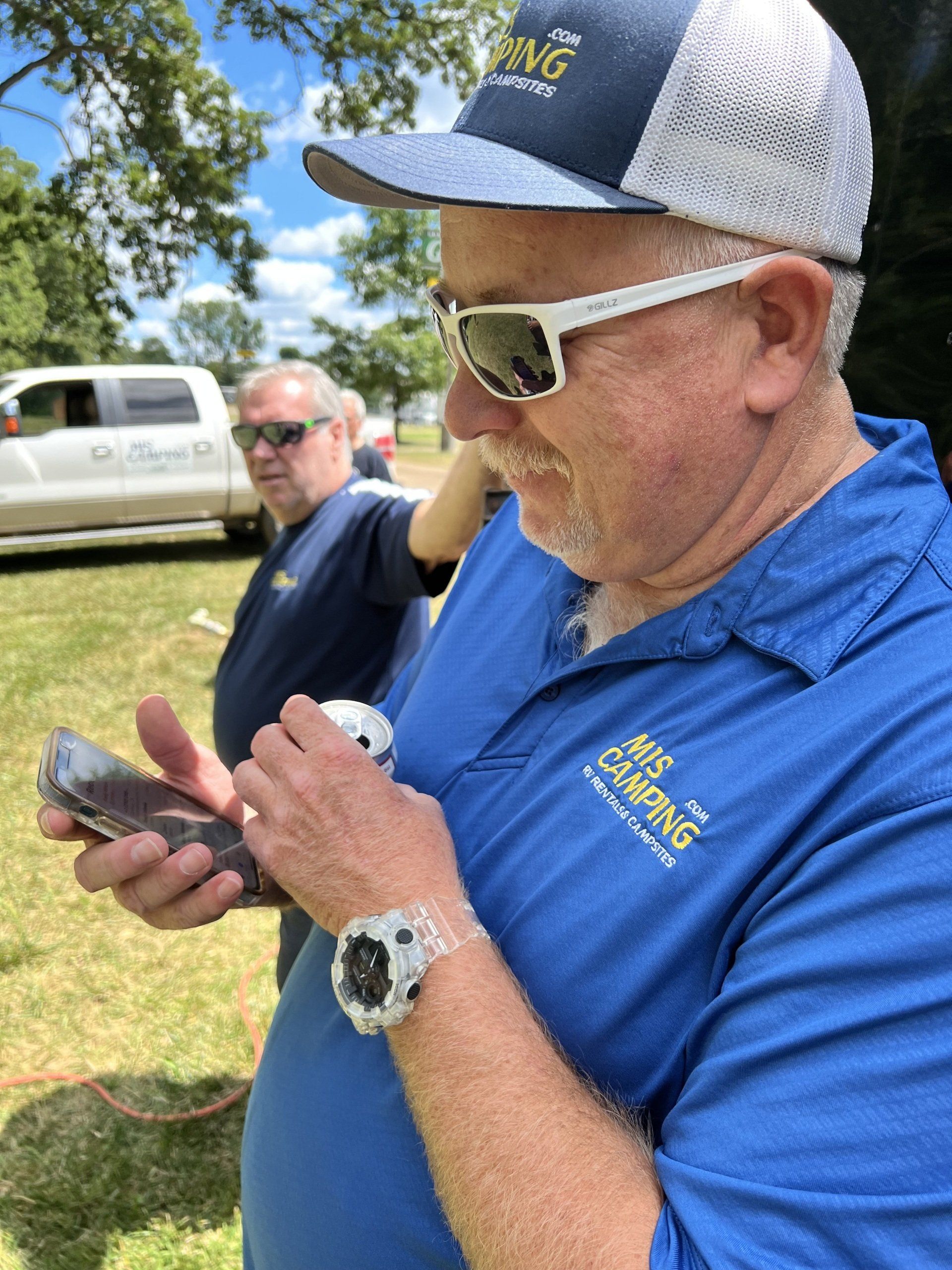 A man wearing a blue shirt with the word camping on it