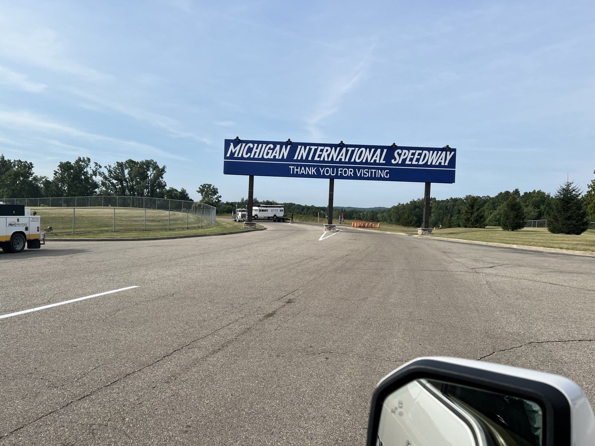 A sign for michigan international speedway is on the side of the road