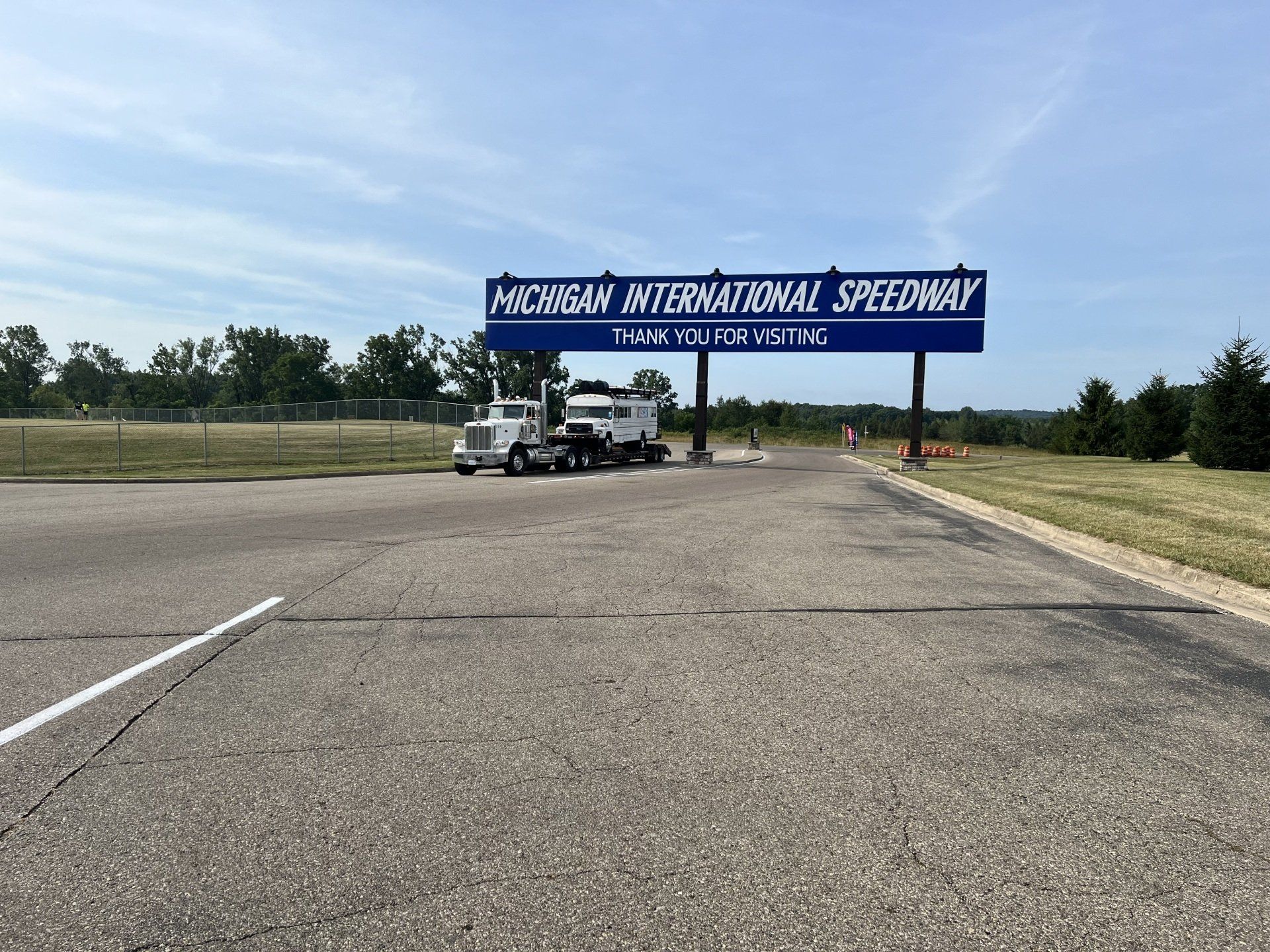 A billboard for michigan international speedway is on the side of a road