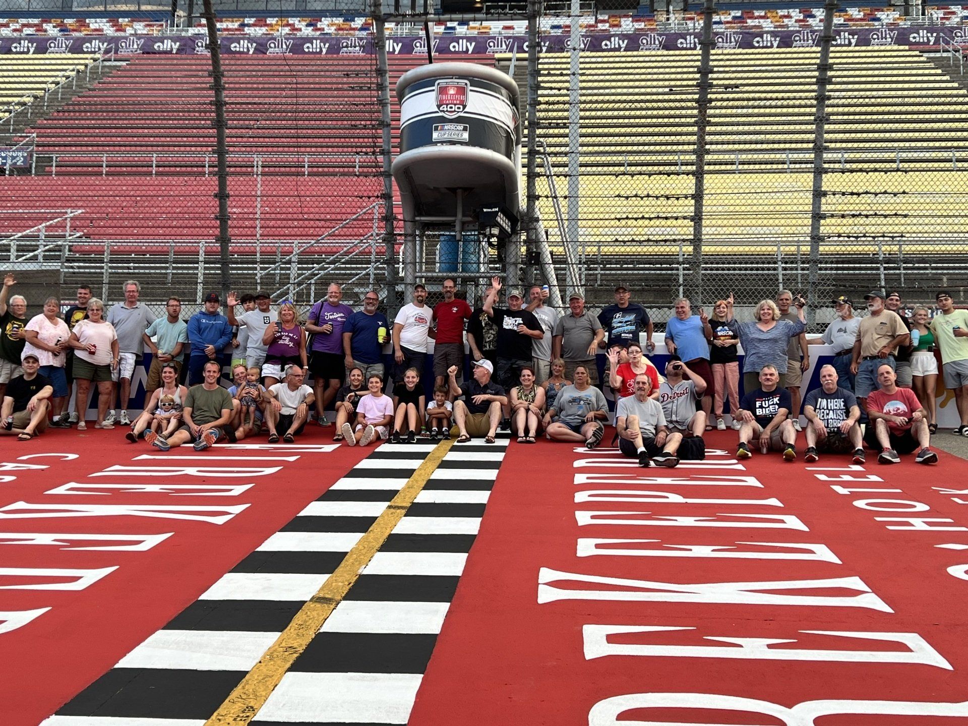 A group of people are posing for a picture in front of a stadium