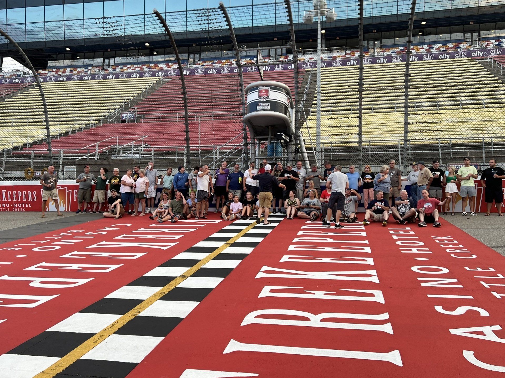 A group of people are posing for a picture on the race track