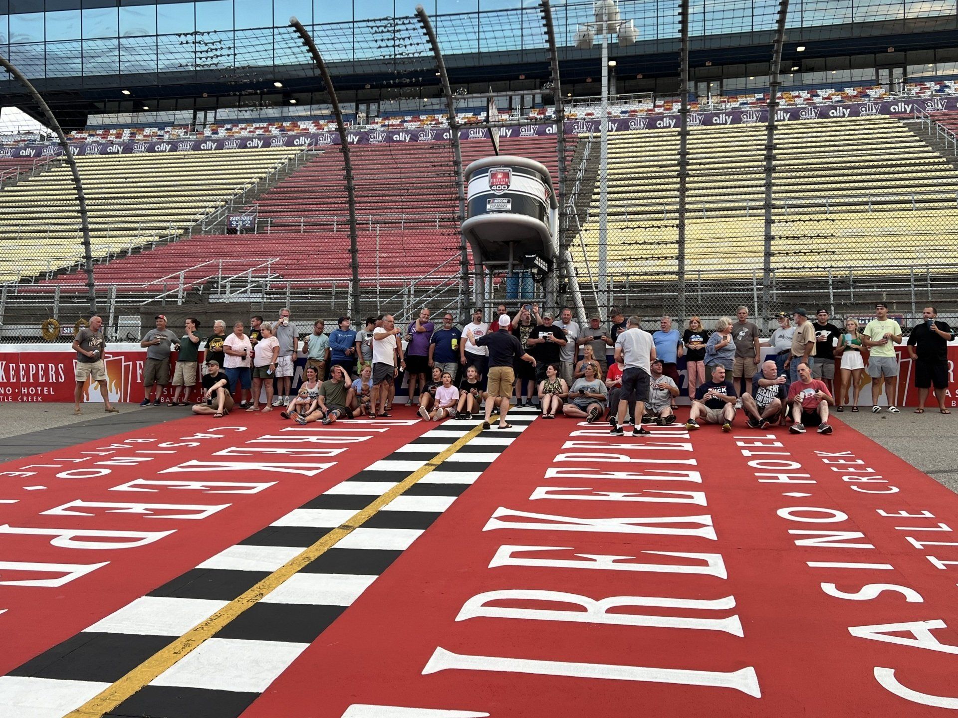 A group of people standing on a race track with a sign that says casino on it
