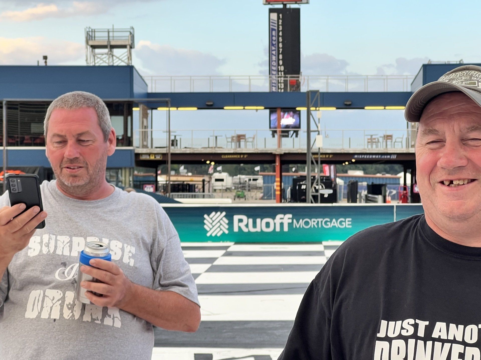 Two men standing in front of a building that says ruoff mortgage