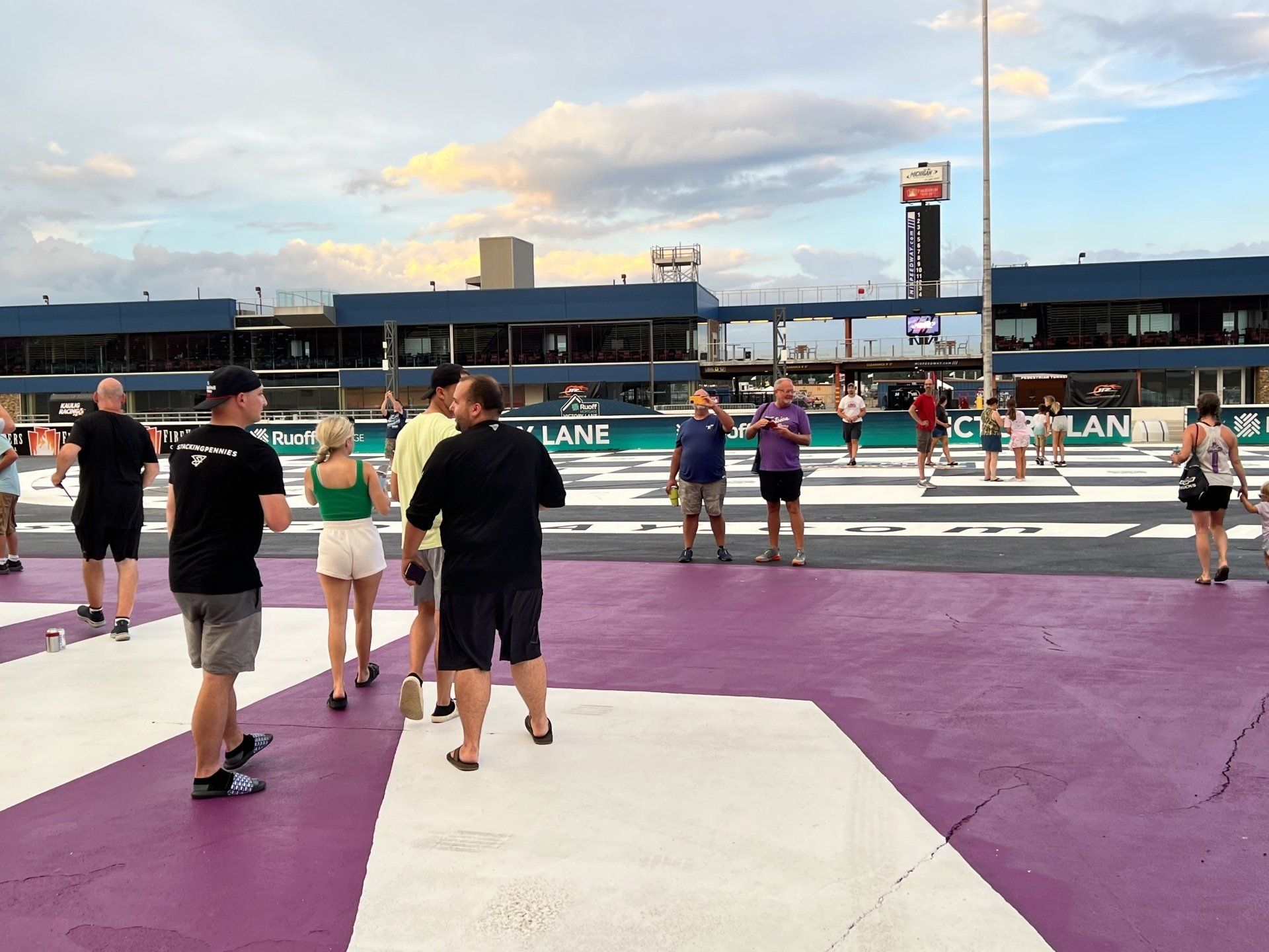 A group of people standing on a purple and white striped floor
