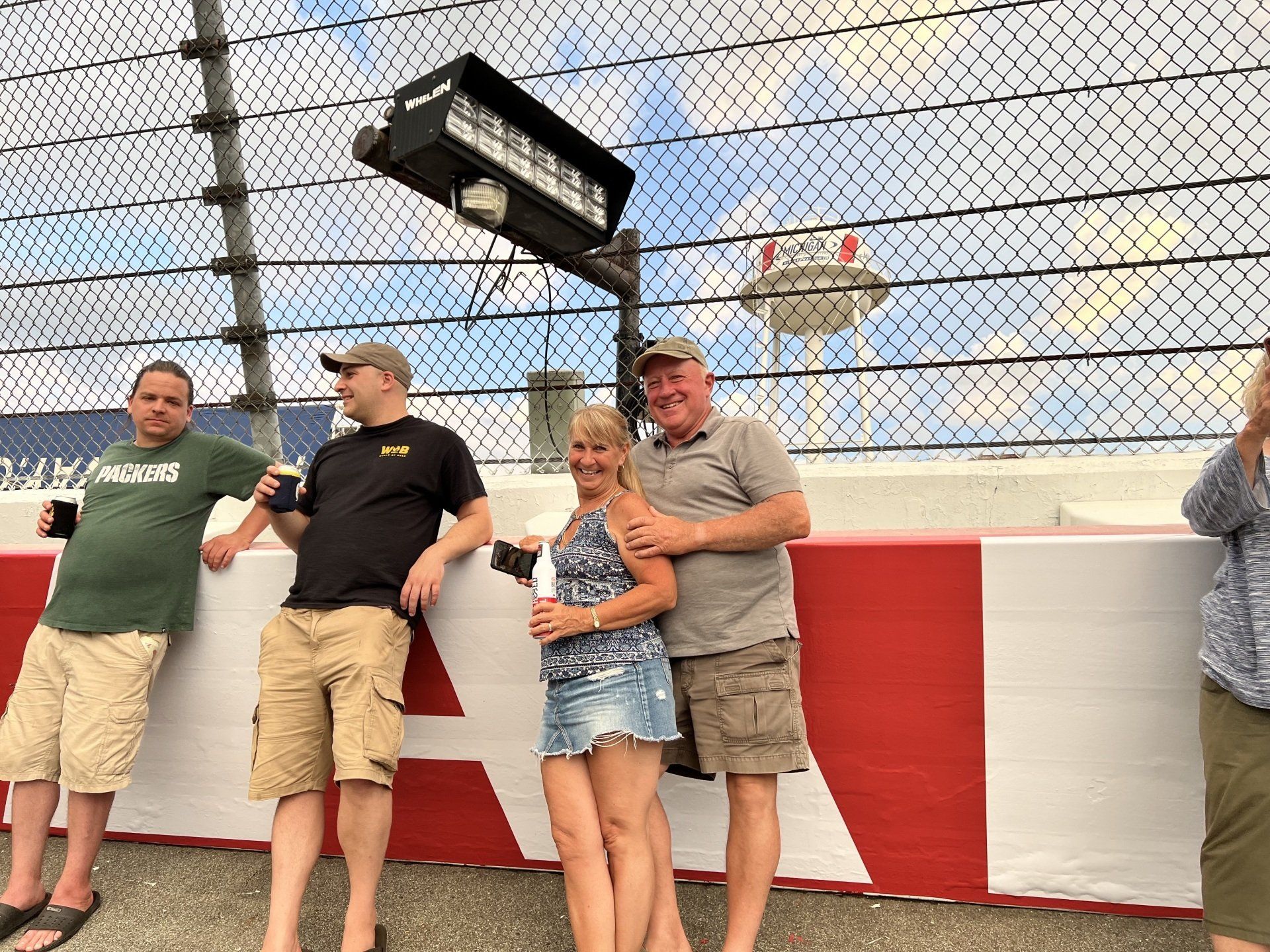 A group of people standing next to each other on a race track.