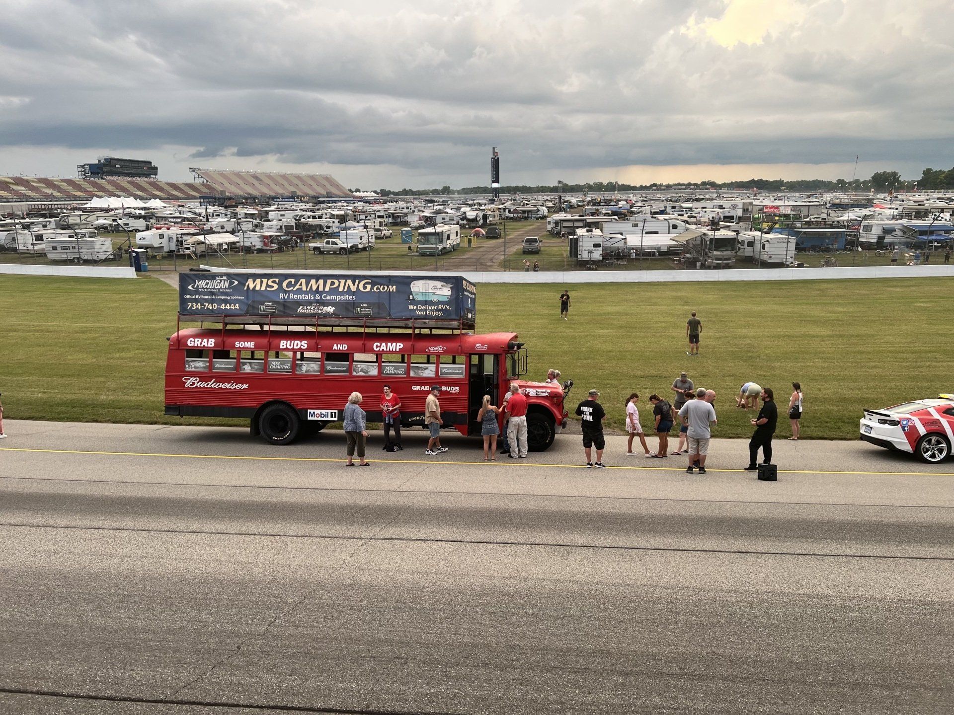 A red bus is parked on the side of a road.