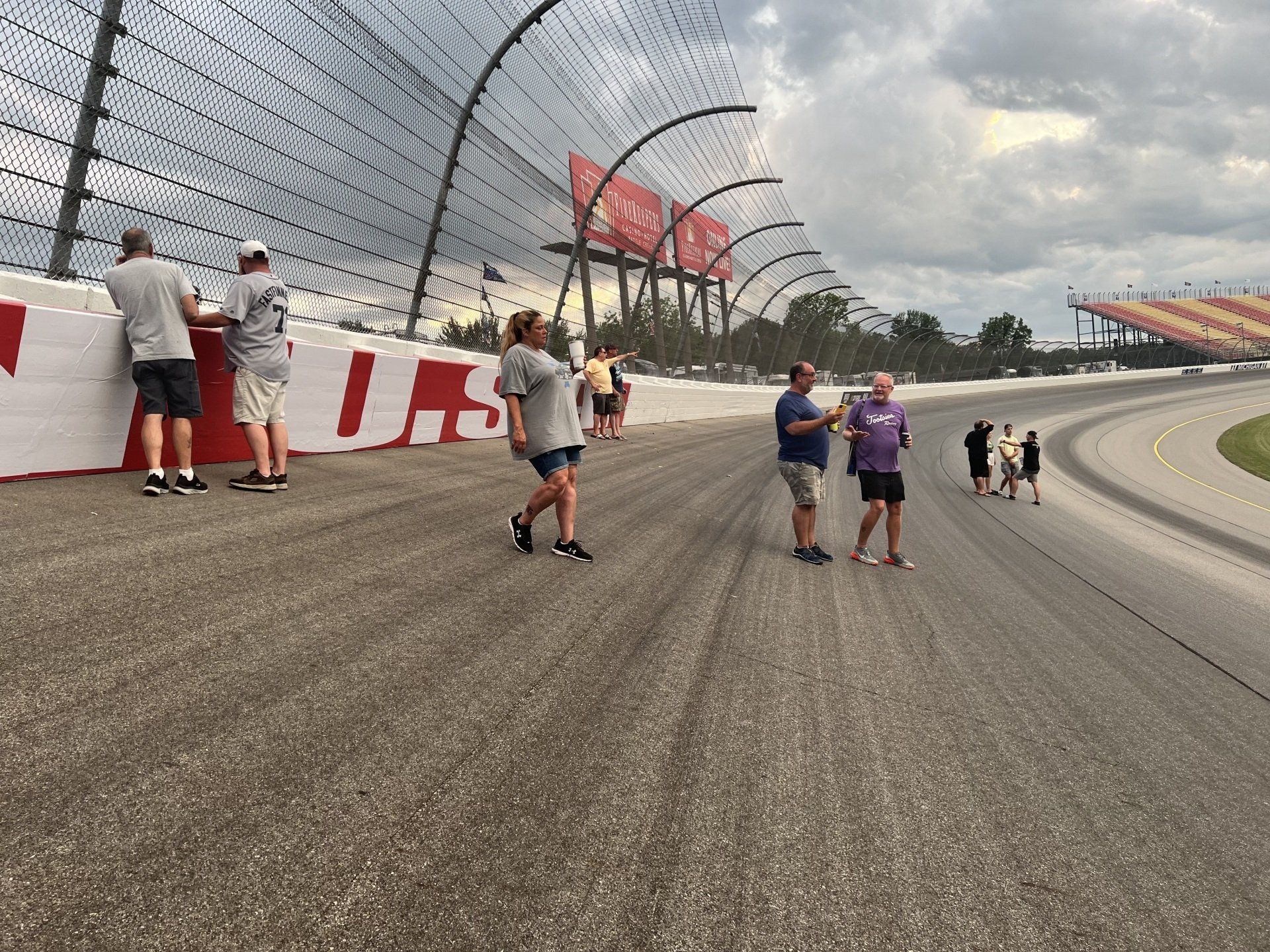 A group of people standing on a race track with a sign that says us