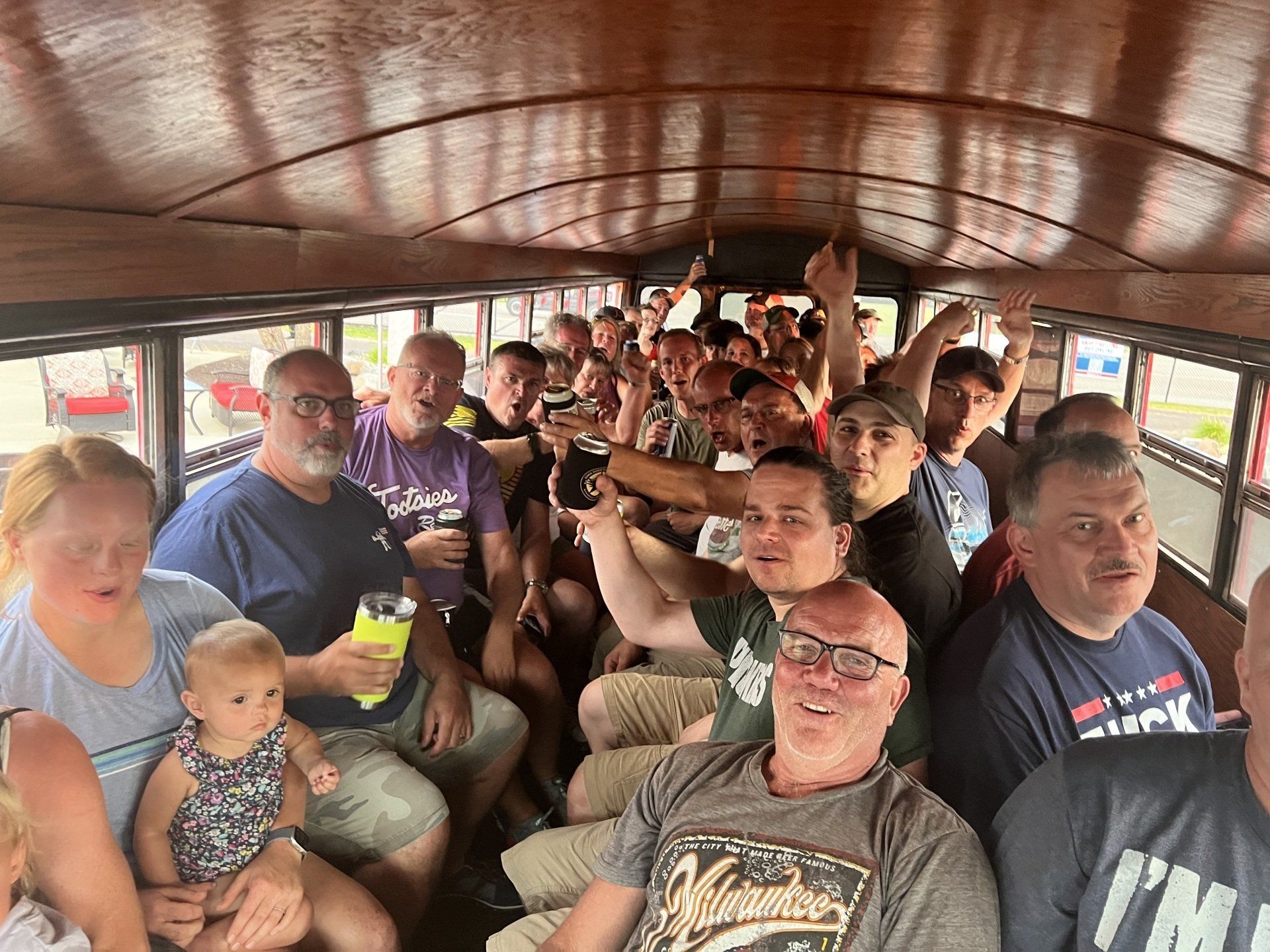 A large group of people are sitting on a bus.