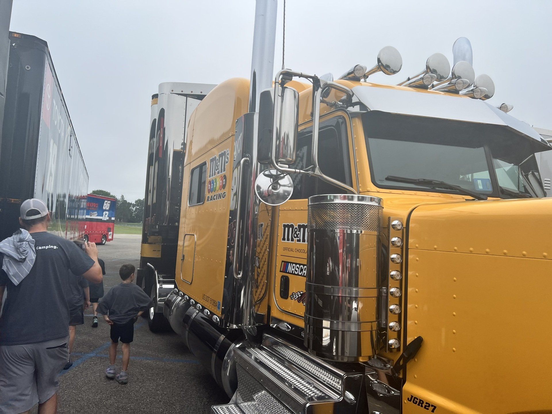 A yellow semi truck with the letters mtn on the side