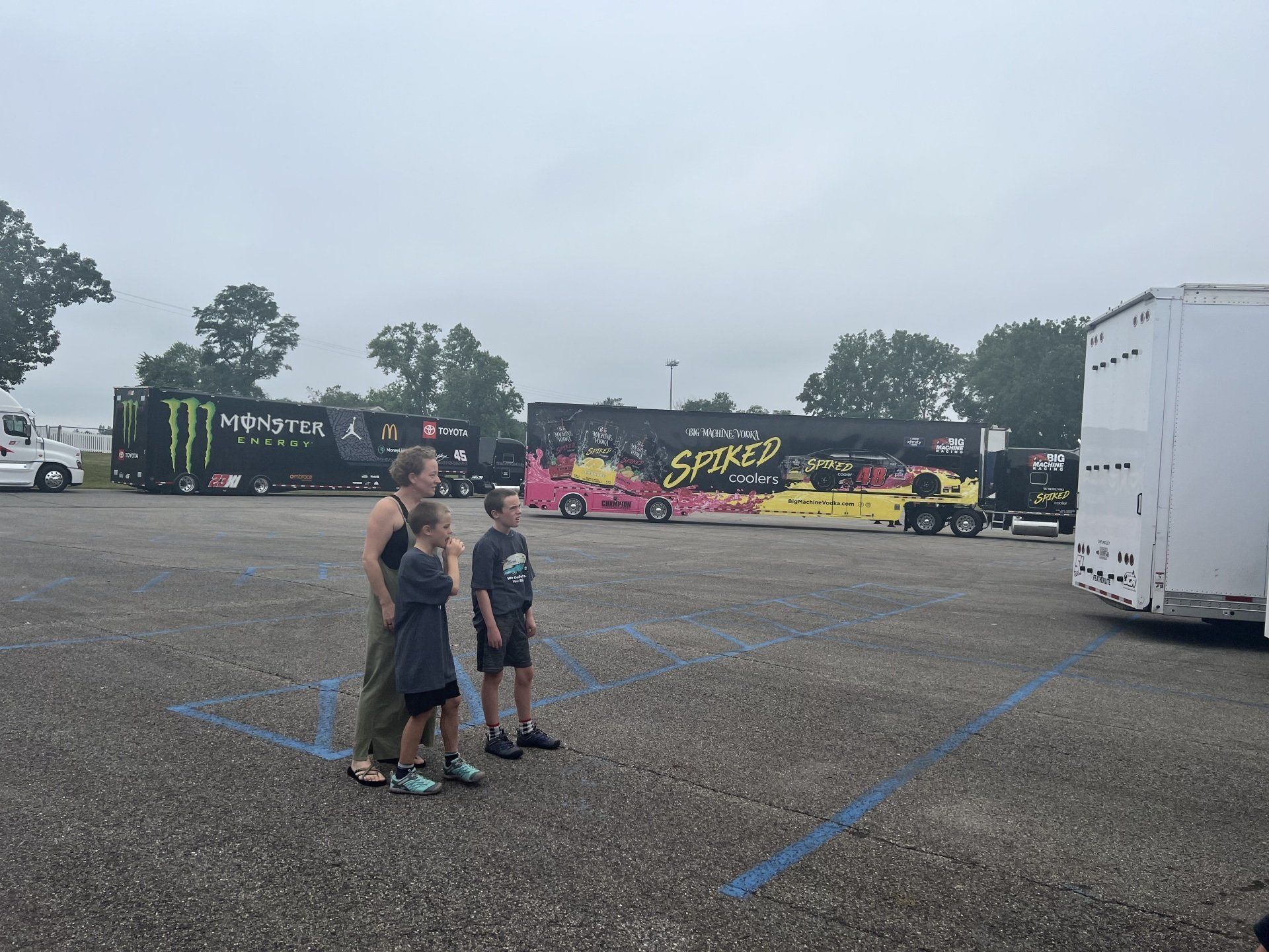 A group of people standing in front of a monster truck