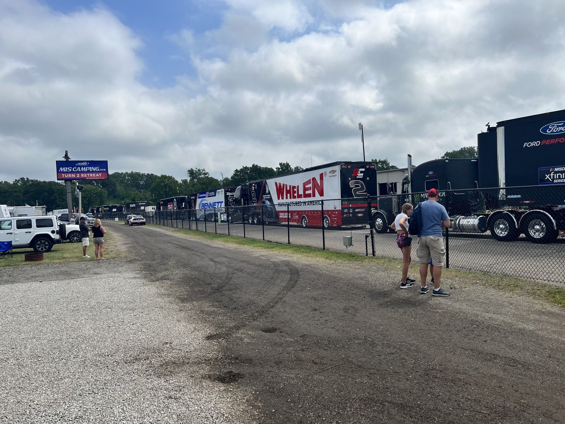 A group of people standing in front of a truck that says wolen