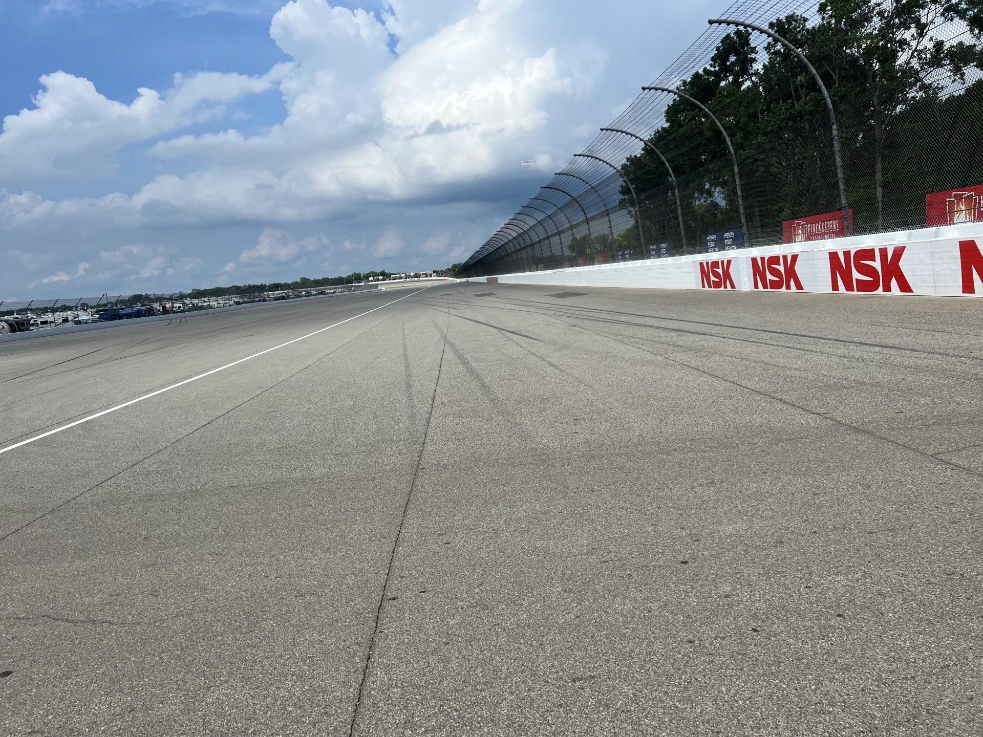 A race track with a fence that says nsk on it